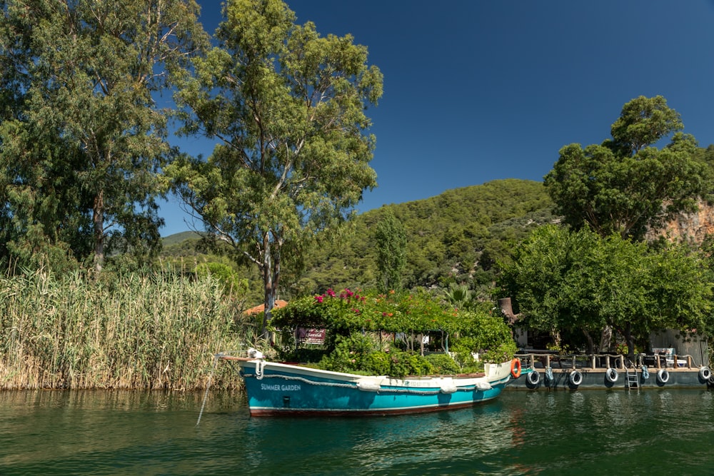 a blue boat is docked on the water