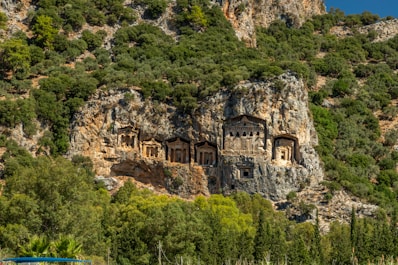 a mountain side with a house built into the side of it