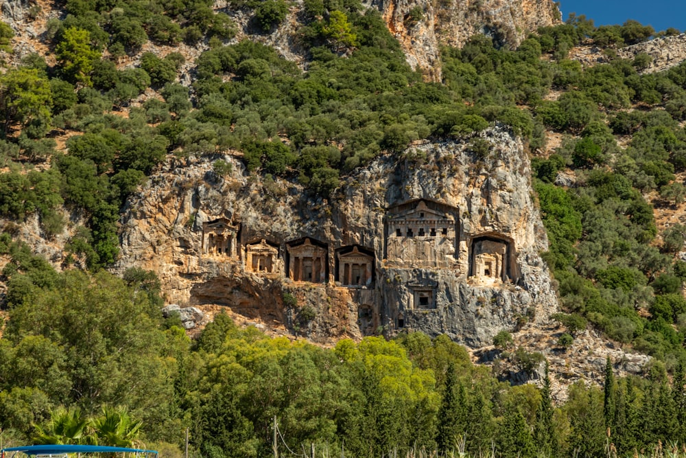 a mountain side with a house built into the side of it