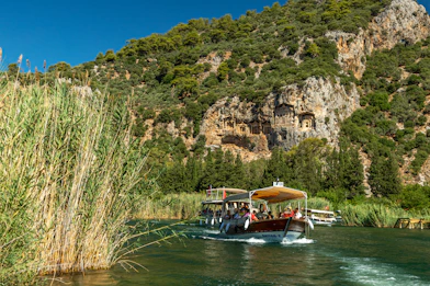 a group of people riding on top of a boat on a river