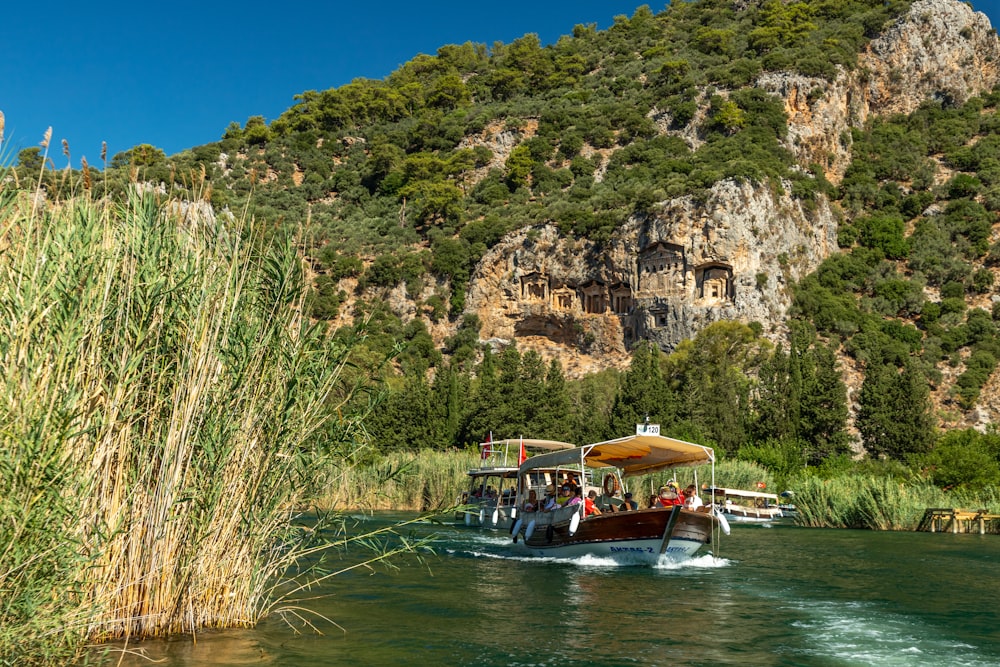 a group of people riding on top of a boat on a river