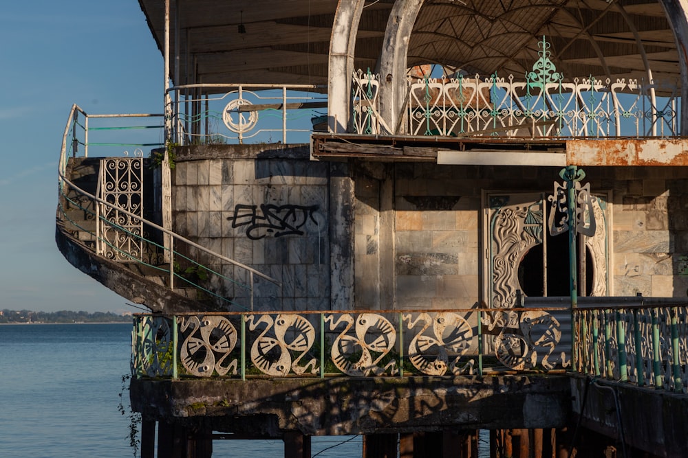 an old building sitting on the side of a body of water