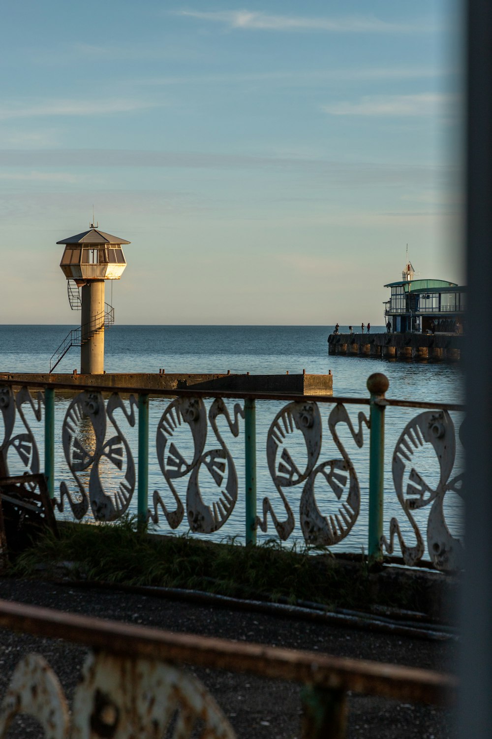 a view of a pier with a clock tower in the distance