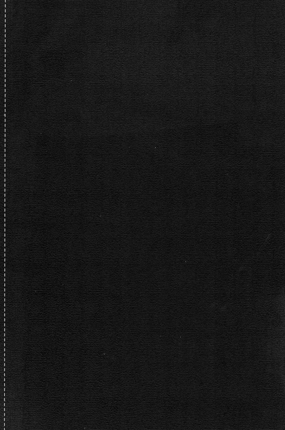 a black book with white stitching on the cover