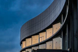 A sleek, minimalist building facade with sharp lines against a twilight sky.