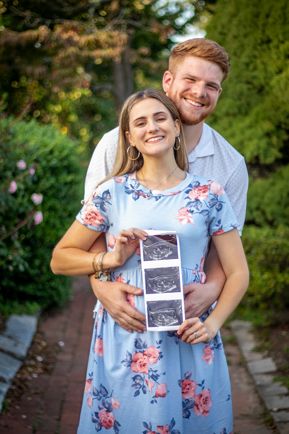 a man and a woman holding a plaque