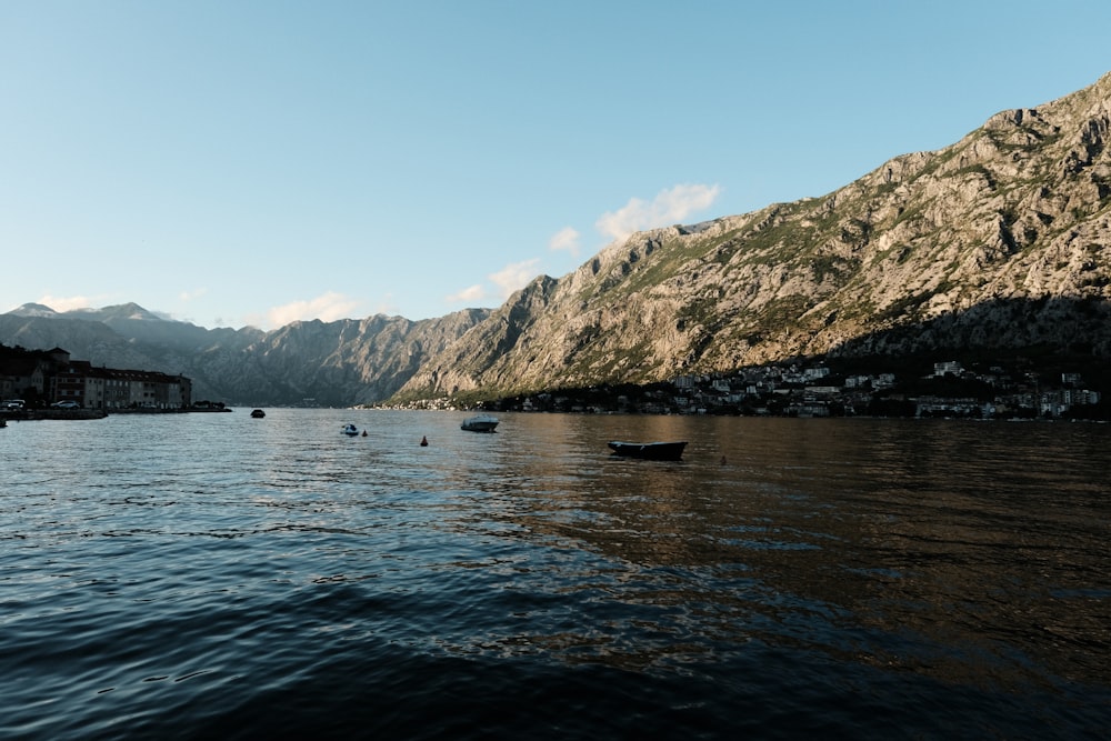 a body of water surrounded by mountains and houses