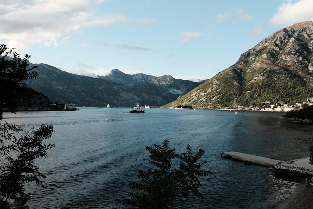 a body of water surrounded by mountains and trees