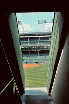 a view of a baseball field from the bottom of a flight of stairs