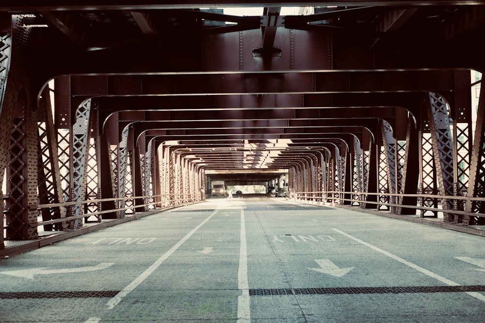 a view of an empty parking lot under a bridge