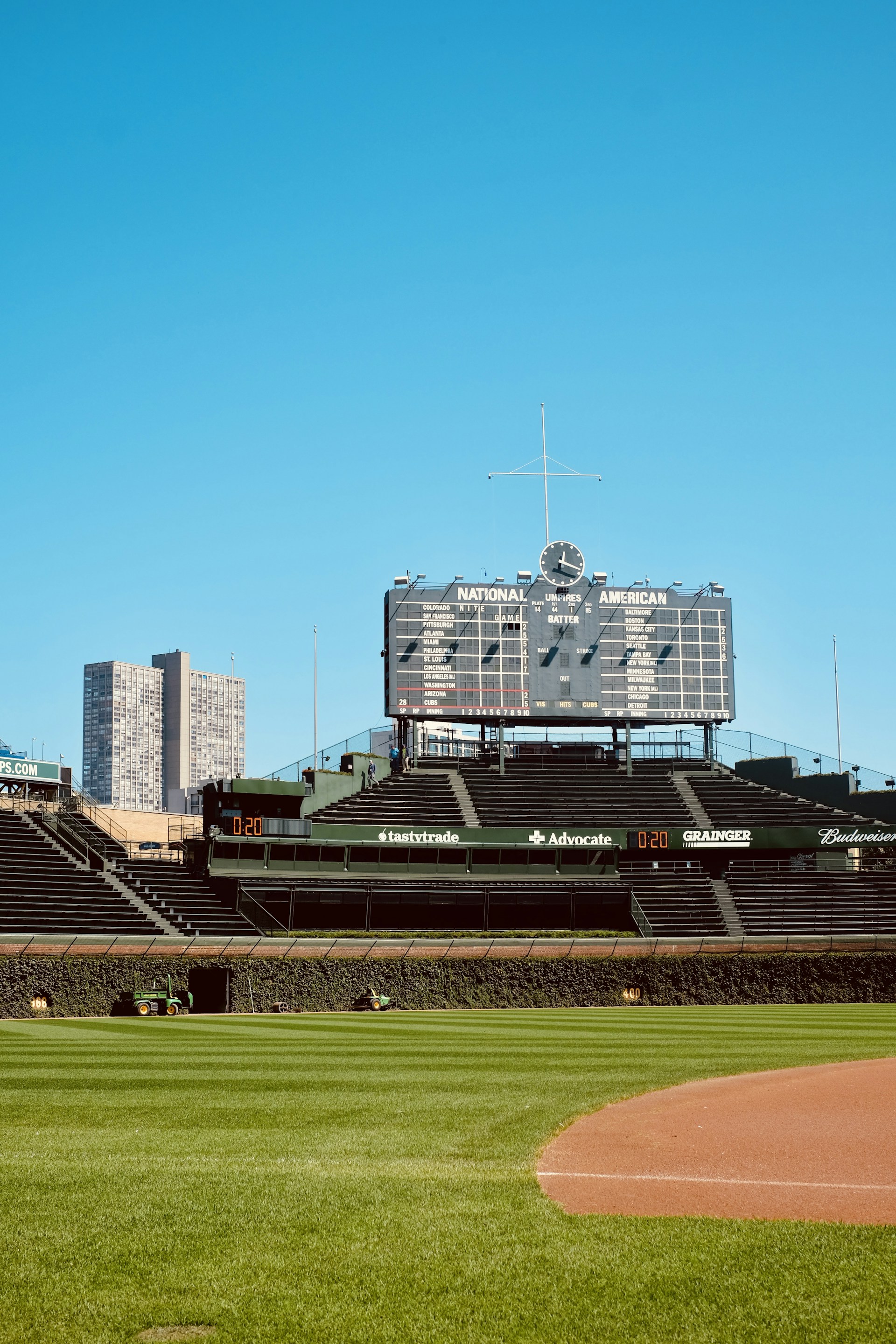 a baseball field with a large scoreboard in the background