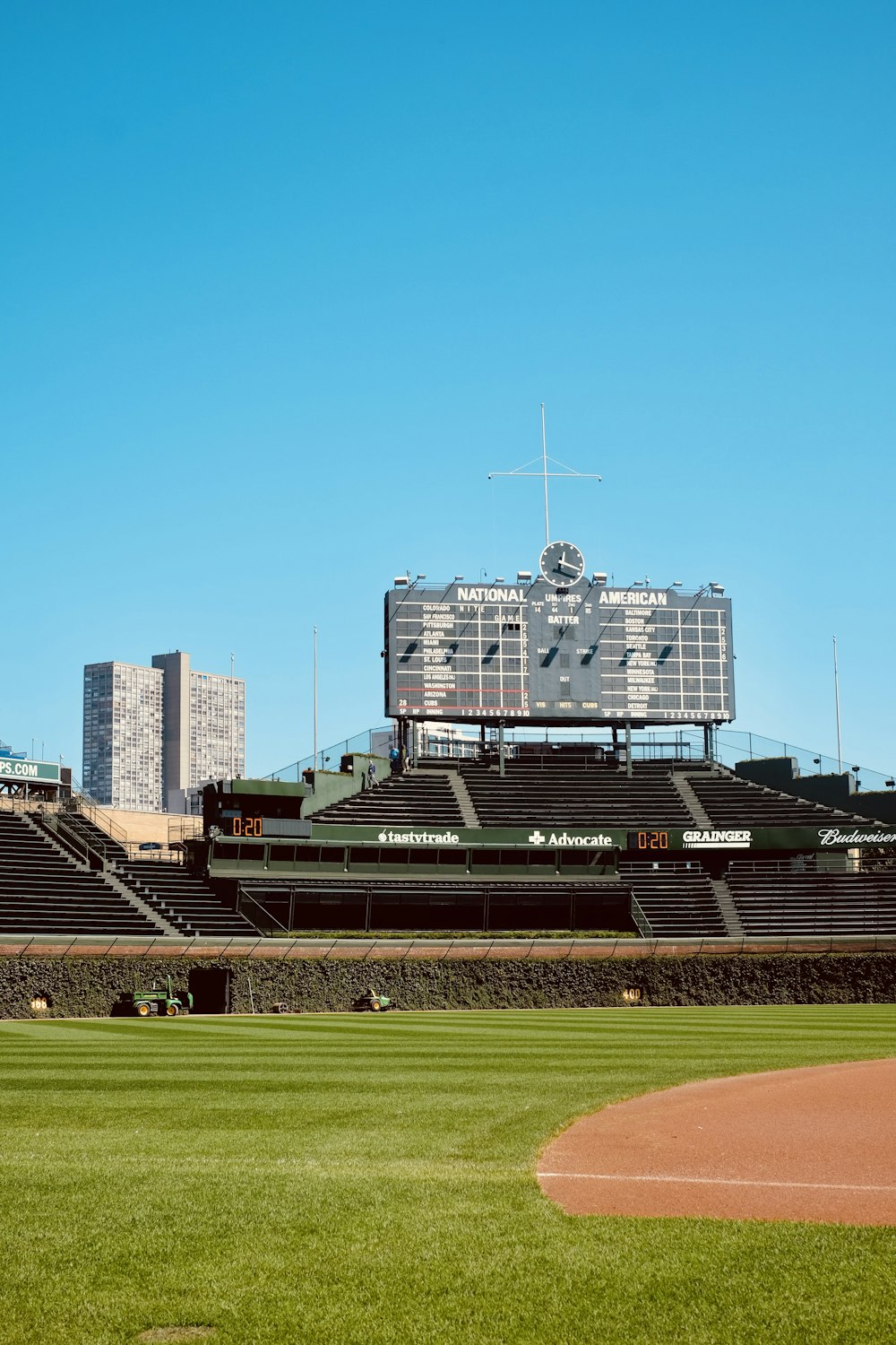 a baseball field with a large scoreboard in the background