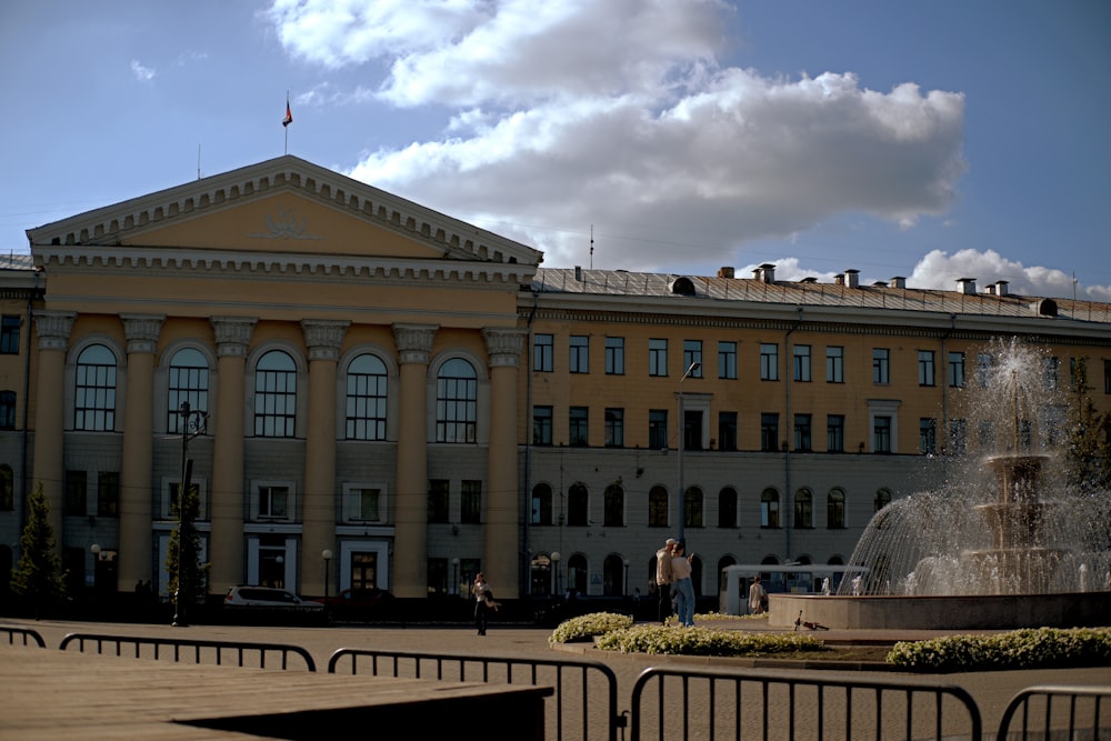 a large building with a fountain in front of it