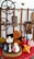 A collection of decorative items arranged on a red surface, featuring various ceramic vases, a wooden heart-shaped plaque, and intricately carved wooden panels depicting a man's face and a horse. There are also industrial-style cog wheels and dried floral arrangements.