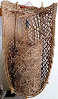 A rustic basket filled with different types of harvested fibers ready for processing.