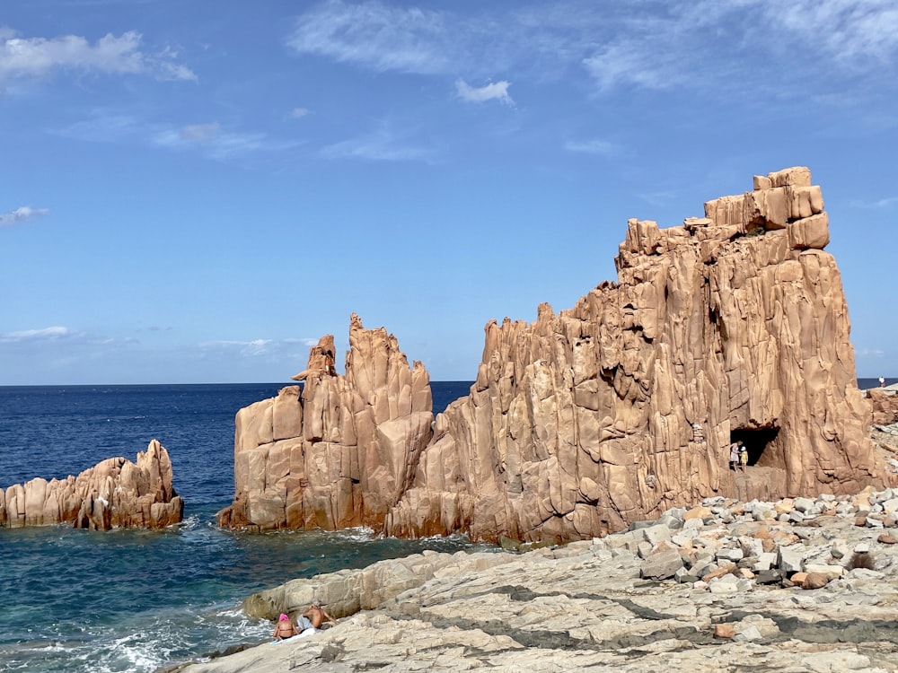 a rocky outcropping next to a body of water