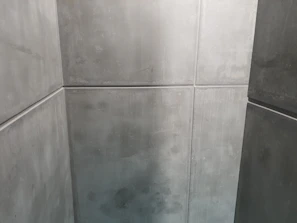 Painters applying a smooth, crisp gray coat to an office wall, enhancing the professional environment