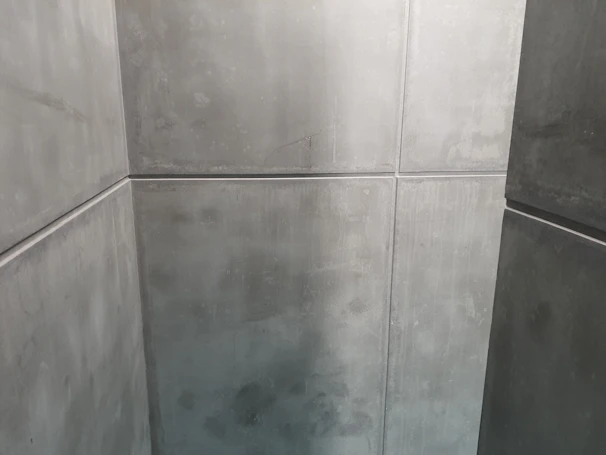 An industrial workspace with walls coated in durable gray paint, showcasing a clean and professional environment.