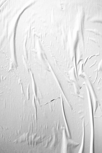 a black and white photo of a white wall