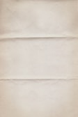 A textured, off-white paper with three horizontal creases running across. The surface appears slightly worn with subtle discoloration and minor graininess.