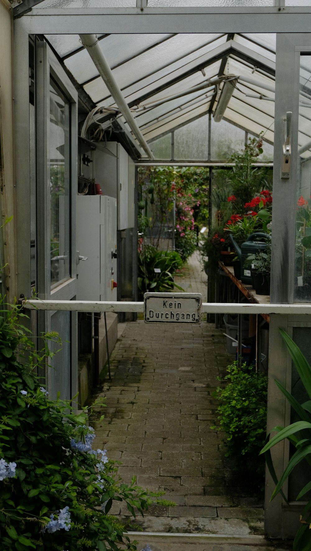 a greenhouse with a sign in the middle of it