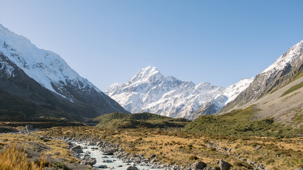 a mountain range with a stream running through it