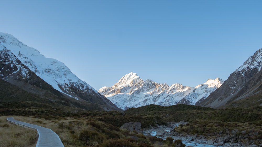 a scenic view of a mountain range with a river running through it