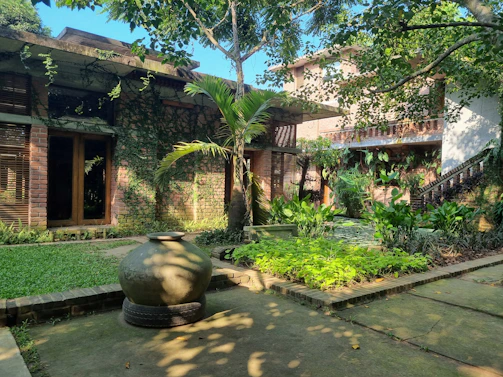 Serene courtyard featuring warm brick pathways and eco-conscious landscaping.