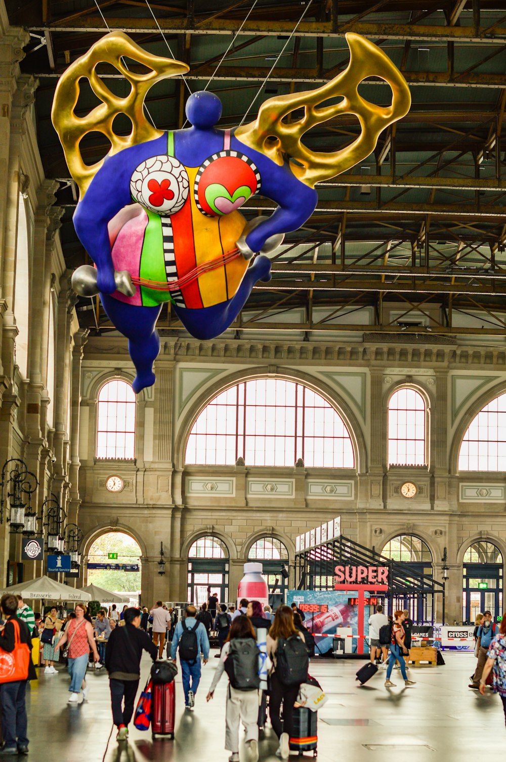 Un gruppo di persone che camminano intorno a una stazione ferroviaria