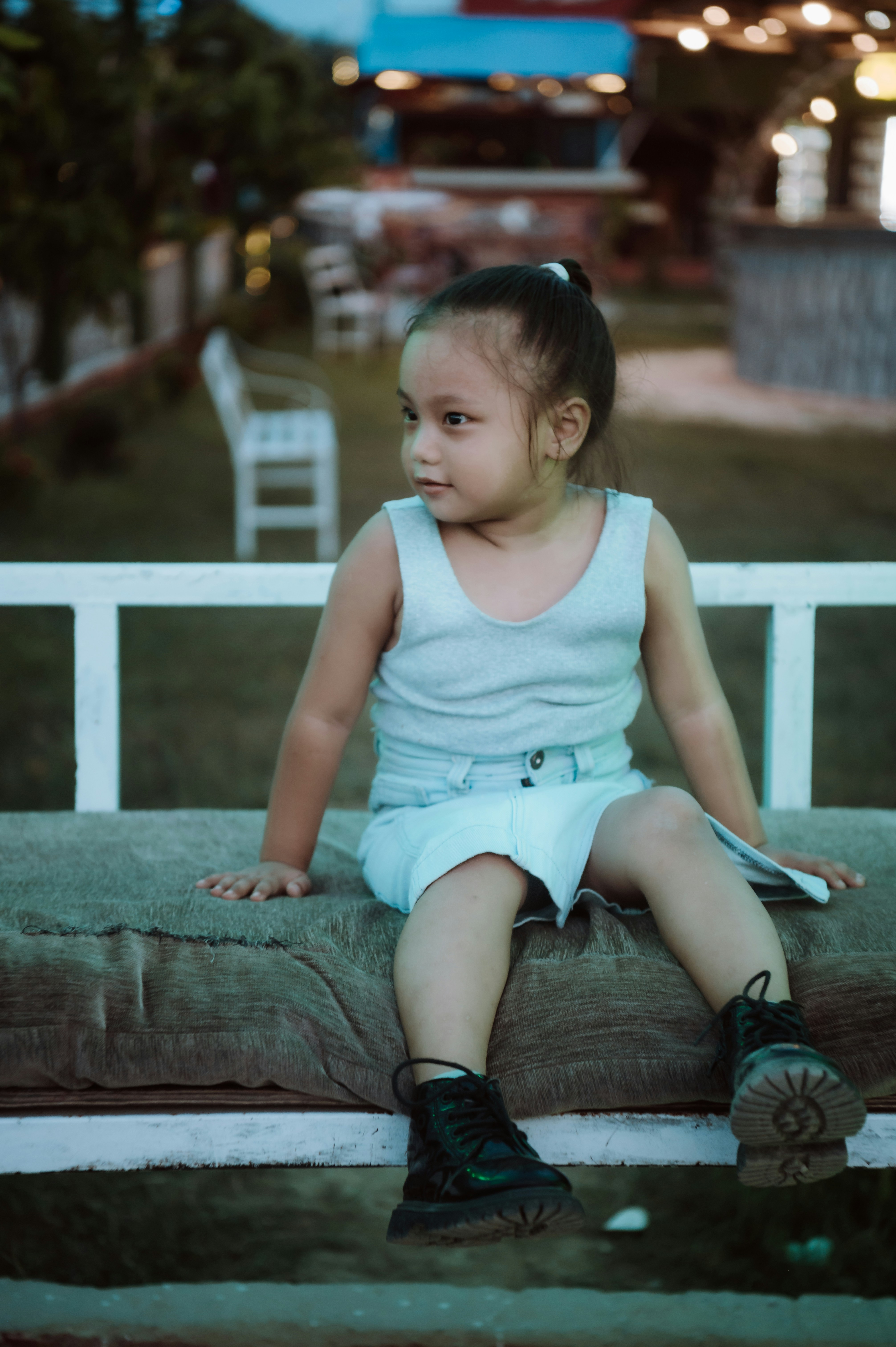 a little girl that is sitting on a bench