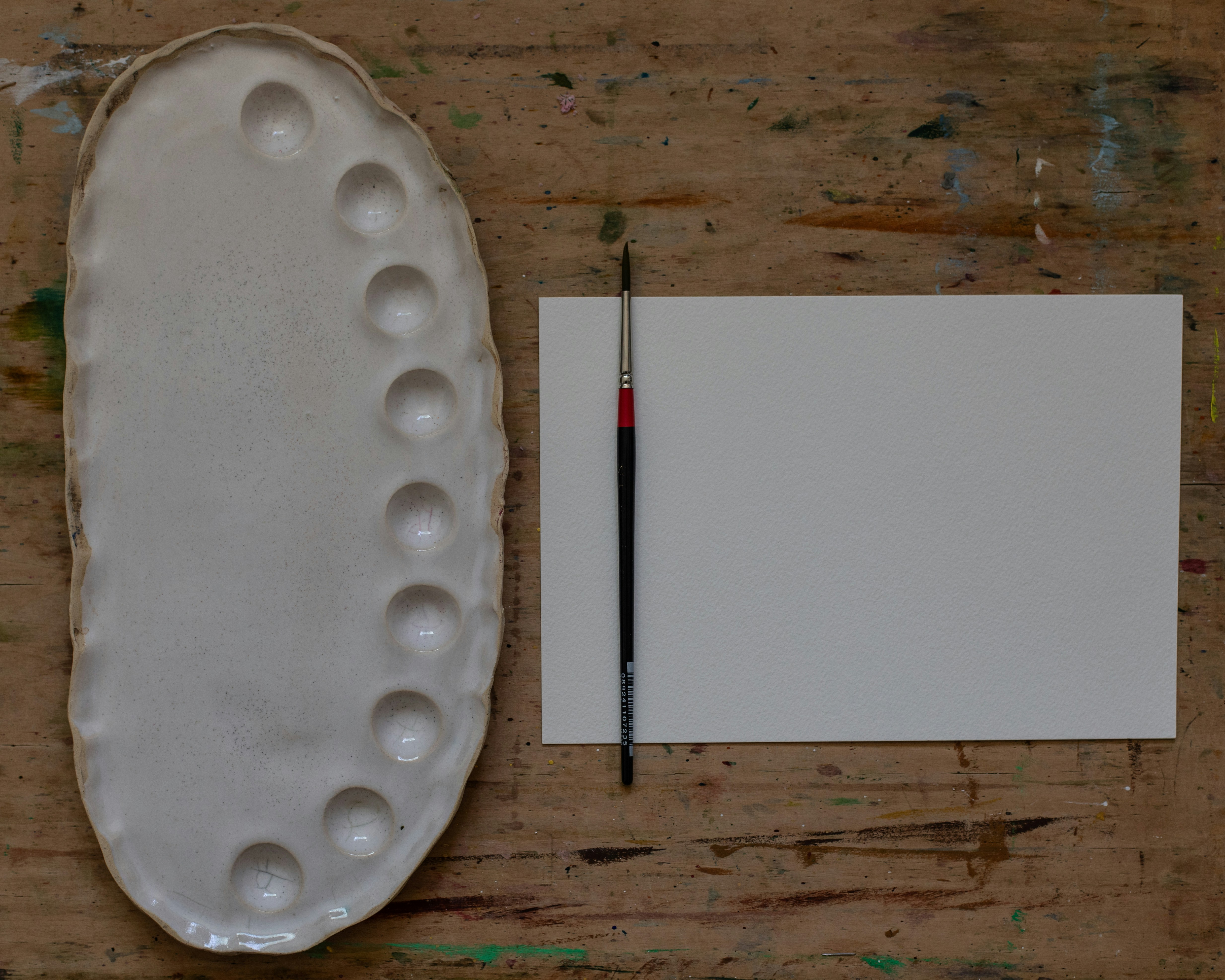 a piece of paper and a paintbrush on a table