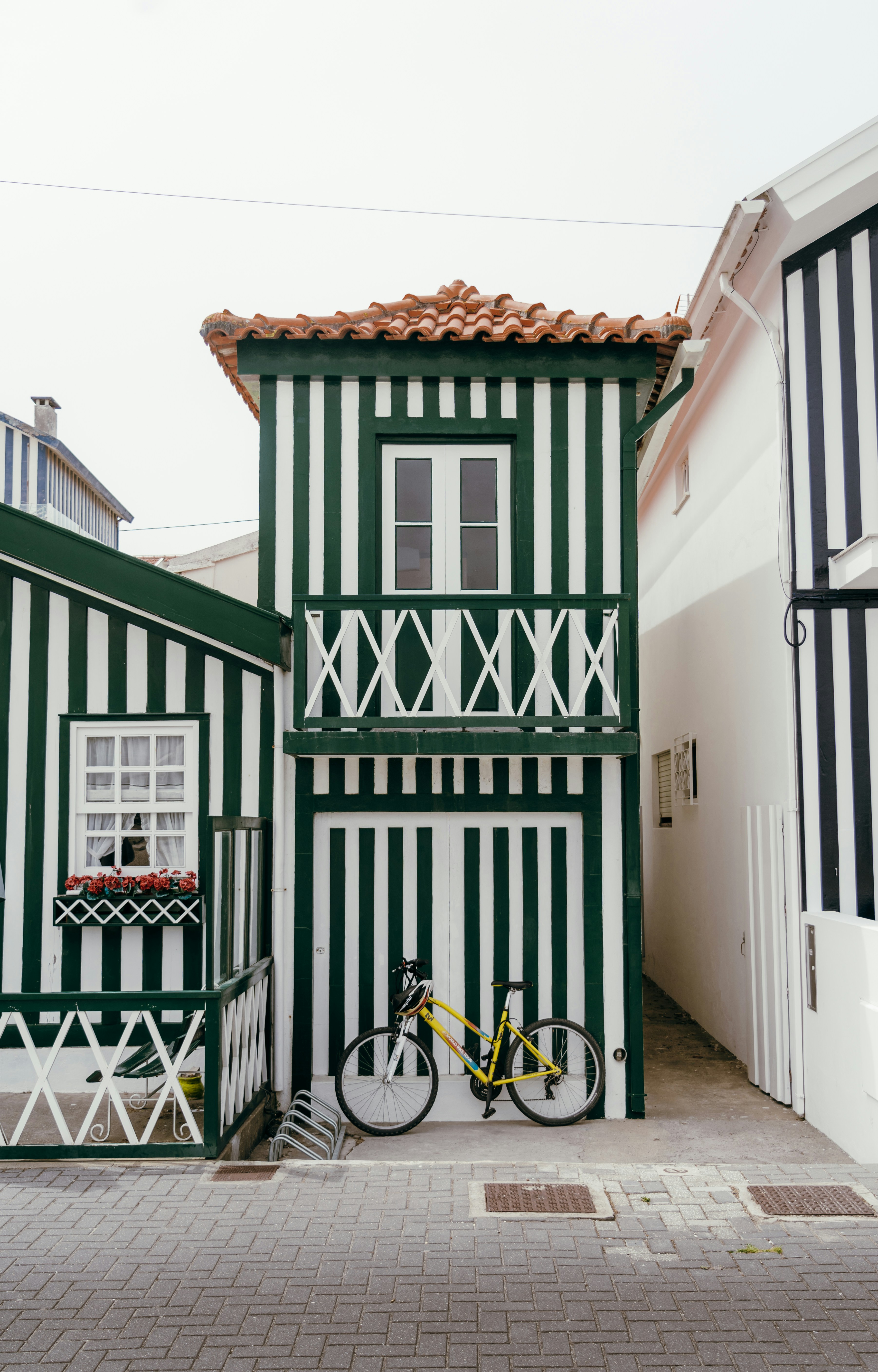 a bike parked in front of a green and white building