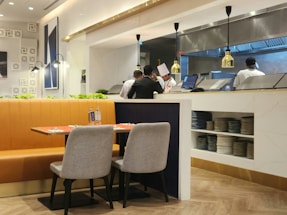 A clean, modern restaurant kitchen with blue and white accents reflecting freshness.