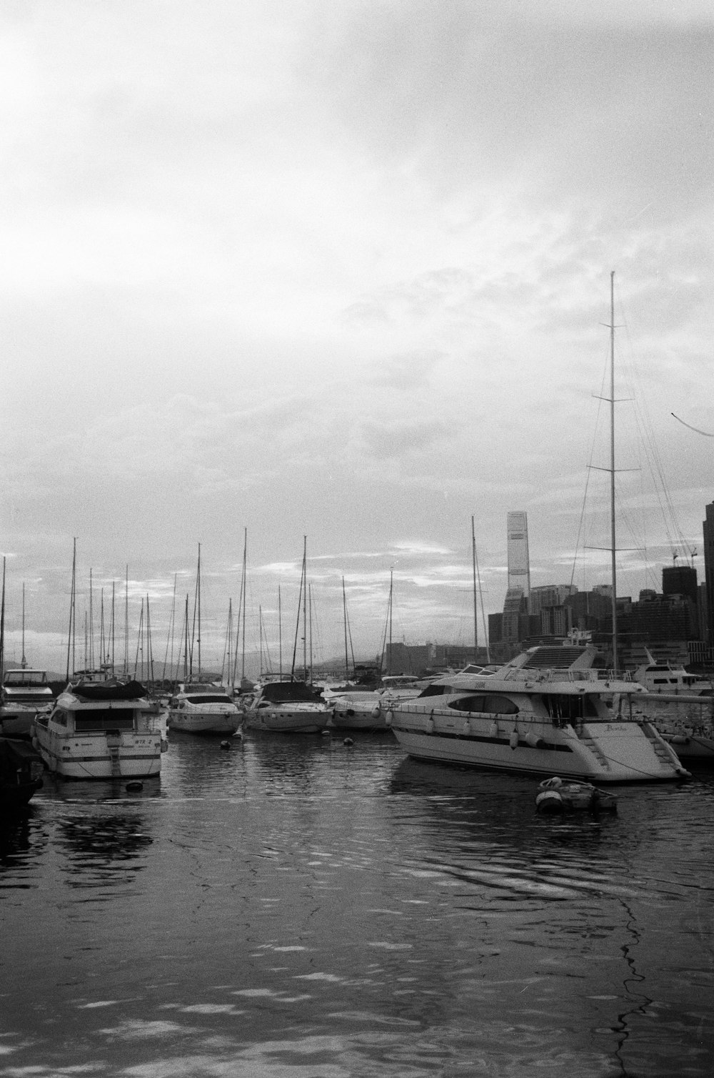 a black and white photo of boats in a harbor