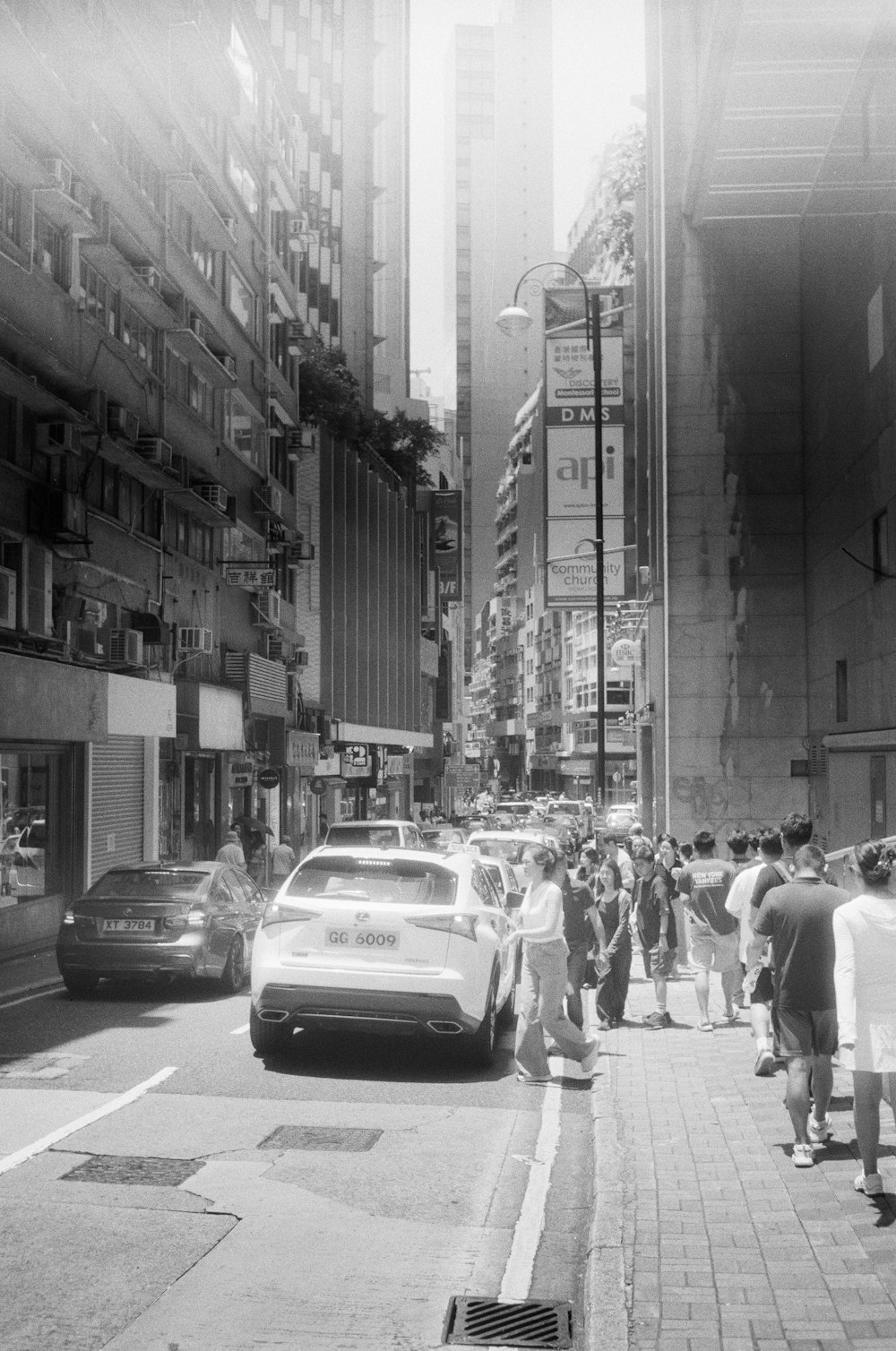 a black and white photo of a busy city street