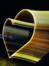 A warm, glowing heart-shaped light illuminating a dark room, symbolizing radiant love.