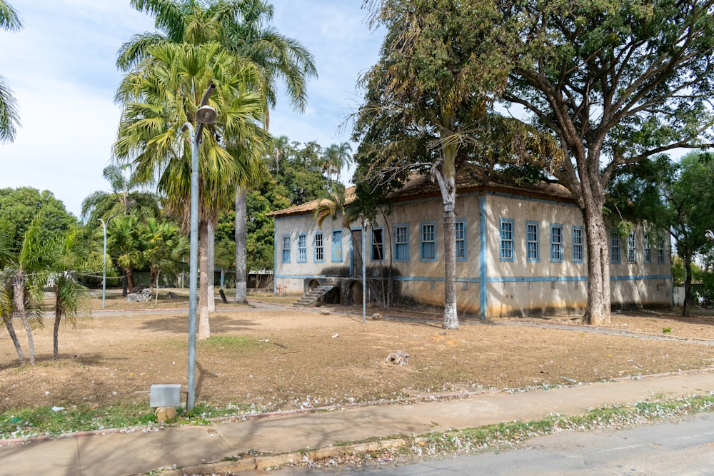 a blue and white building surrounded by palm trees