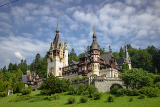 a large castle with towers on top of a hill