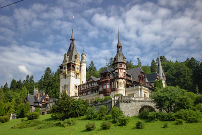 a large castle with towers on top of a hill
