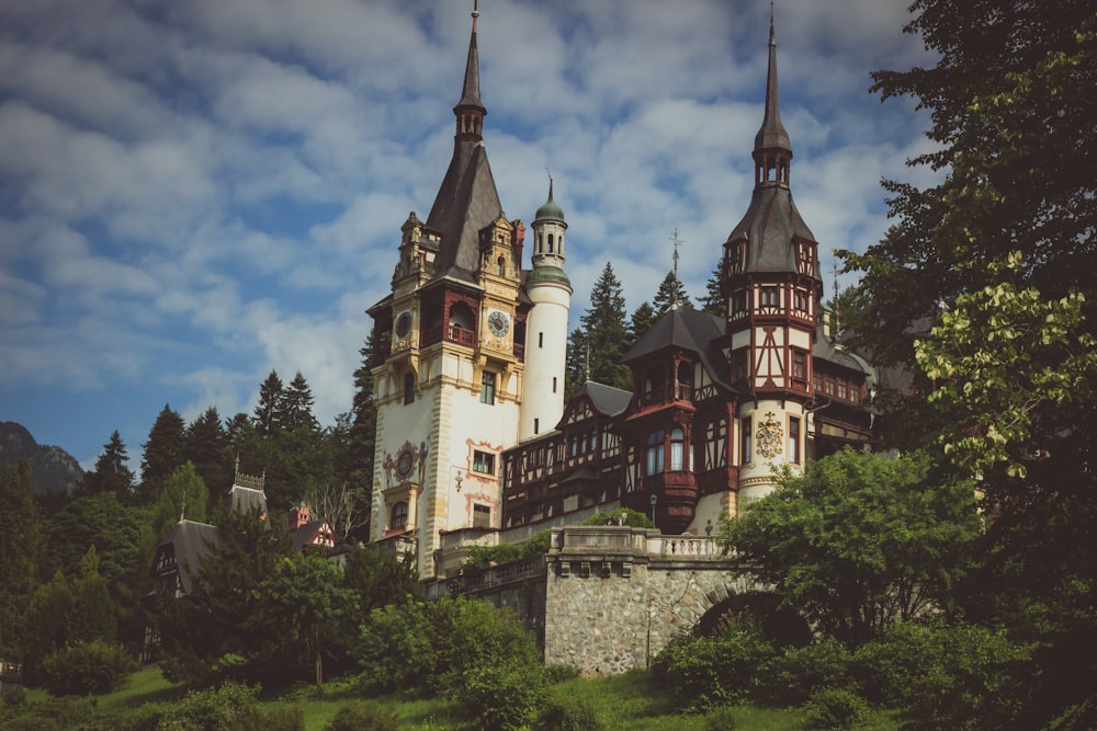 a large castle with two towers on top of a hill