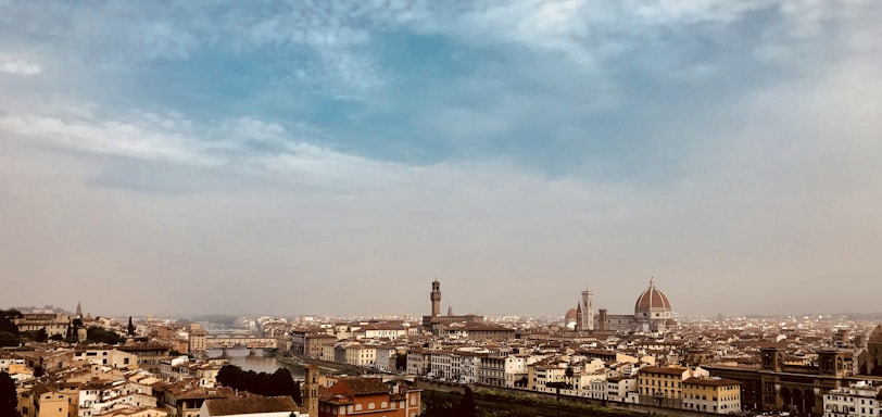 A panoramic view of a historic European city street, alive with culture and charm.