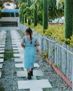 A young girl walking safely on a well-lit path with a guardian nearby