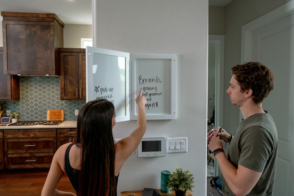 a man and a woman standing in a kitchen