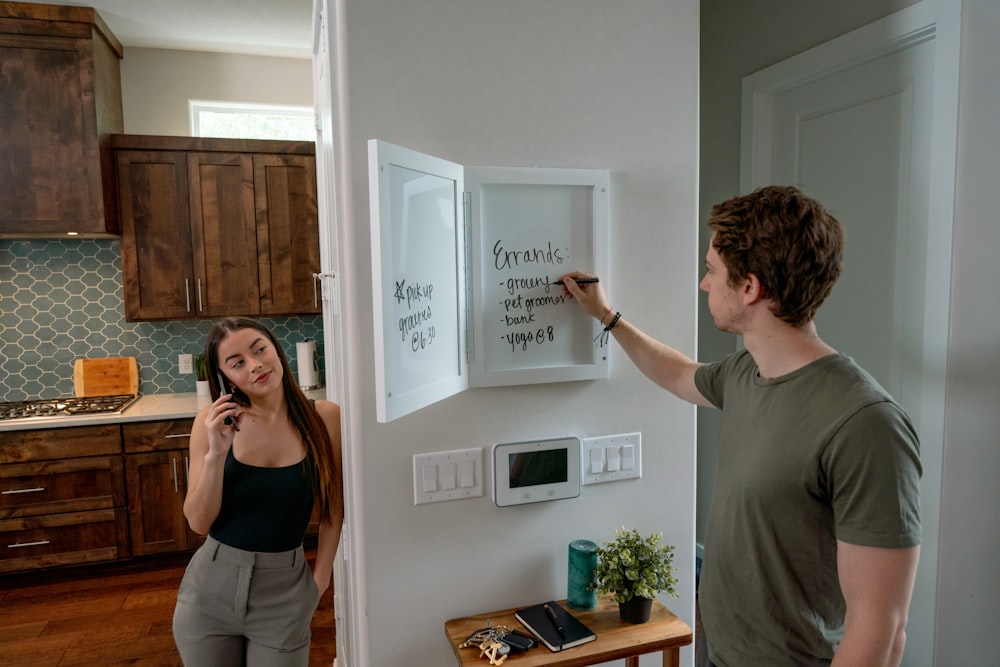 a man and a woman standing in a kitchen