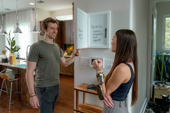 Friendly real estate agent discussing plans with a young couple