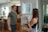 A smiling real estate agent handing keys to a happy client in a modern home.