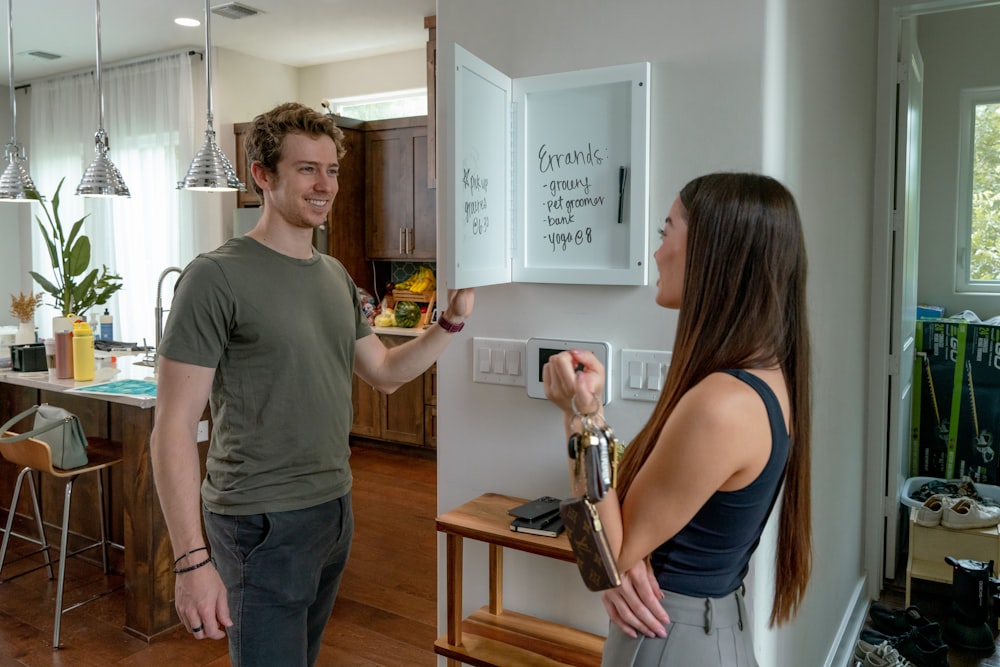 a man and a woman standing in a kitchen