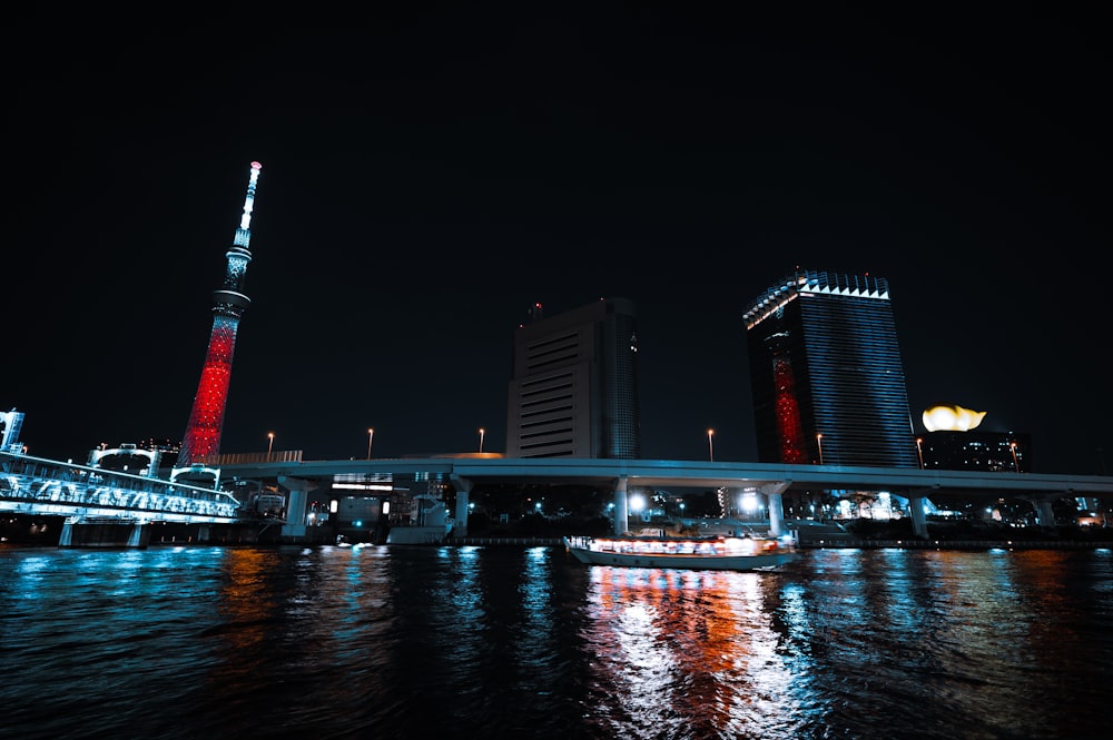 a city at night with lights reflecting in the water