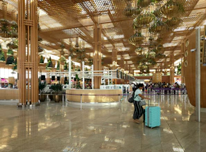 Traveler receiving a warm airport welcome with vibrant floral arrangements