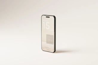 Close-up of a sleek iPhone 15 displayed on a black and gold background, highlighting its premium design.